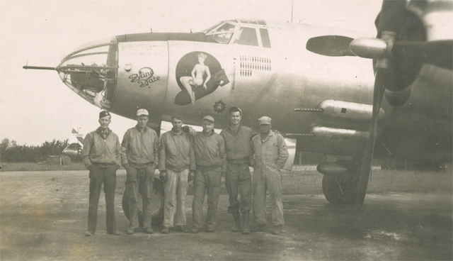 Unidentified man sitting on bomb. "Rivenhall, England" written on reverse